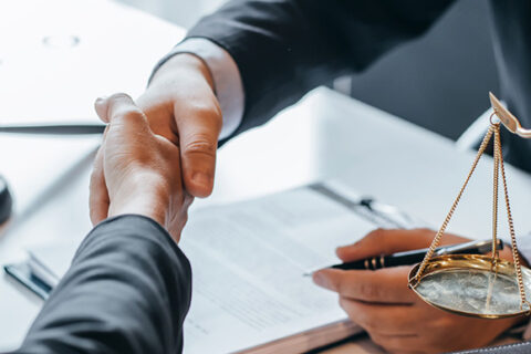 Lawyer and client shake hands in Ontario, Canada office