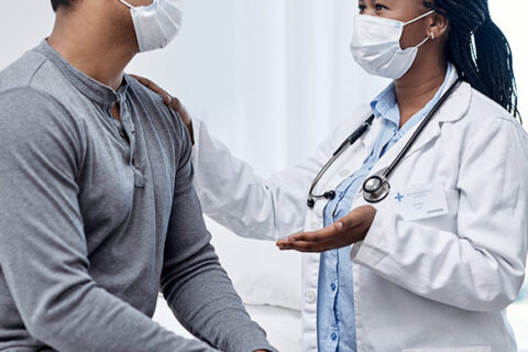 Medical worker talking to patient about asbestos exposure in Ontario, Canada
